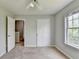 Bright carpeted bedroom with neutral walls, and an open doorway to the hallway at 2355 Glen Chase Ln, Lawrenceville, GA 30044