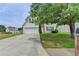 Inviting two-story home with a well-maintained lawn and a long driveway leading to the garage at 2355 Glen Chase Ln, Lawrenceville, GA 30044