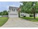 Charming two-story home with a two-car garage, manicured lawn, and mature landscaping at 2355 Glen Chase Ln, Lawrenceville, GA 30044