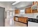 Bright kitchen with wooden cabinets, tile flooring, and stainless steel appliances at 2355 Glen Chase Ln, Lawrenceville, GA 30044