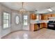 Eat-in kitchen showcases tile flooring, light fixtures, wood cabinetry, and gas range at 2355 Glen Chase Ln, Lawrenceville, GA 30044