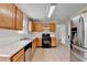 Spacious eat-in kitchen with stainless steel appliances, light wood cabinetry, and tile flooring at 2355 Glen Chase Ln, Lawrenceville, GA 30044