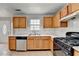 Well-lit kitchen featuring wooden cabinets, tile flooring, and modern appliances at 2355 Glen Chase Ln, Lawrenceville, GA 30044