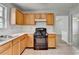 Updated kitchen features light wood cabinets, gas range, tile floors and neutral paint at 2355 Glen Chase Ln, Lawrenceville, GA 30044