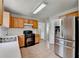 Spacious eat-in kitchen boasts stainless steel appliances, ample cabinetry, and tile floors at 2355 Glen Chase Ln, Lawrenceville, GA 30044