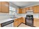 Bright kitchen features wood cabinets, white countertops, tile backsplash, and gas range at 2355 Glen Chase Ln, Lawrenceville, GA 30044