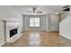 Open-concept living room with fireplace, natural lighting, and convenient access to entry at 2355 Glen Chase Ln, Lawrenceville, GA 30044