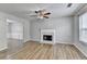 Inviting living room with a fireplace, ceiling fan, and large windows for natural light at 2355 Glen Chase Ln, Lawrenceville, GA 30044
