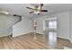 Open-concept living room with hardwood floors, ceiling fan, and dining room at 2355 Glen Chase Ln, Lawrenceville, GA 30044