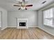 Open living area with fireplace, ceiling fan, and access to entryway and stairs at 2355 Glen Chase Ln, Lawrenceville, GA 30044