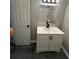 Stylish bathroom vanity with black fixtures and white cabinets on gray wood-look flooring at 3730 Clovis Nw Ct, Atlanta, GA 30331