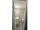 Compact bathroom showcasing sleek vanity and modern fixtures with gray wood-look flooring at 3730 Clovis Nw Ct, Atlanta, GA 30331