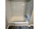 Bright white bathtub with tiled walls offers a clean and modern feel at 3730 Clovis Nw Ct, Atlanta, GA 30331