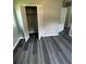 Bedroom with an open closet, gray plank flooring and base molding at 3730 Clovis Nw Ct, Atlanta, GA 30331