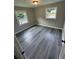 Bedroom with gray wood-look floors and two bright windows at 3730 Clovis Nw Ct, Atlanta, GA 30331