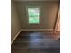 Bedroom with a window, gray plank flooring and base molding at 3730 Clovis Nw Ct, Atlanta, GA 30331