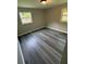This bedroom has gray wood-look floors and two bright windows at 3730 Clovis Nw Ct, Atlanta, GA 30331