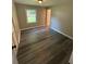 Bedroom with gray wood-look flooring and window with backyard view at 3730 Clovis Nw Ct, Atlanta, GA 30331