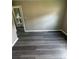 Bedroom features gray walls, gray wood-look flooring, and a doorway that leads to a bathroom at 3730 Clovis Nw Ct, Atlanta, GA 30331