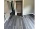 Bedroom with sleek gray flooring and an open closet, offering a blend of style and functionality at 3730 Clovis Nw Ct, Atlanta, GA 30331