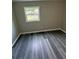 This bedroom has wood-look floors and a bright window at 3730 Clovis Nw Ct, Atlanta, GA 30331