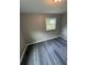 Bedroom with gray wood-look floors and bright window at 3730 Clovis Nw Ct, Atlanta, GA 30331