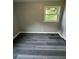 Bedroom with a window, gray plank flooring and base molding at 3730 Clovis Nw Ct, Atlanta, GA 30331