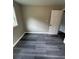 Bedroom with sleek gray flooring and a modern door, offering a clean and stylish design at 3730 Clovis Nw Ct, Atlanta, GA 30331
