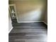 Bedroom with gray wood-look floors leads to a bath area at 3730 Clovis Nw Ct, Atlanta, GA 30331