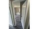 View into a bedroom with sleek gray flooring and a window, seen through an open white paneled door at 3730 Clovis Nw Ct, Atlanta, GA 30331