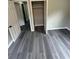 A gray wood-look floor in a bedroom with a closet at 3730 Clovis Nw Ct, Atlanta, GA 30331