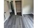 This bedroom features grey wood-look flooring and gray walls, plus a door leading to closet at 3730 Clovis Nw Ct, Atlanta, GA 30331