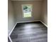 This bedroom has gray wood-look floors and a bright window at 3730 Clovis Nw Ct, Atlanta, GA 30331
