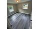 Cozy bedroom featuring new grey flooring and two windows offering plenty of natural light at 3730 Clovis Nw Ct, Atlanta, GA 30331