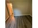 Bedroom with gray plank flooring, base molding and an electrical outlet in the background at 3730 Clovis Nw Ct, Atlanta, GA 30331