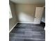Bedroom with gray wood-look floors and a white door at 3730 Clovis Nw Ct, Atlanta, GA 30331