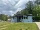 Charming single-story home with light blue brick, black trim, and a well-maintained front yard at 3730 Clovis Nw Ct, Atlanta, GA 30331