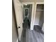 View down a hallway with gray walls, gray wood-look flooring, and several white doors at 3730 Clovis Nw Ct, Atlanta, GA 30331