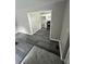 Hallway view of the kitchen with white cabinets and black range oven at 3730 Clovis Nw Ct, Atlanta, GA 30331