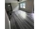 Open-concept living room featuring new gray vinyl flooring and natural light at 3730 Clovis Nw Ct, Atlanta, GA 30331
