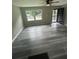 Modern living room featuring gray wood flooring and a black ceiling fan at 3730 Clovis Nw Ct, Atlanta, GA 30331