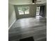 Bright living room with modern gray vinyl flooring and a ceiling fan at 3730 Clovis Nw Ct, Atlanta, GA 30331