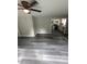Spacious living room featuring new gray vinyl flooring and a ceiling fan at 3730 Clovis Nw Ct, Atlanta, GA 30331