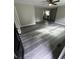 This living room features new gray wood flooring and ceiling fan at 3730 Clovis Nw Ct, Atlanta, GA 30331