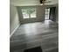 Bright living room featuring modern gray flooring, ceiling fan, and a view of the front door at 3730 Clovis Nw Ct, Atlanta, GA 30331