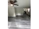 Open-concept living room features a ceiling fan and luxury vinyl plank flooring at 3730 Clovis Nw Ct, Atlanta, GA 30331
