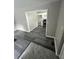 Open living area with a view into the kitchen, featuring gray wood floors at 3730 Clovis Nw Ct, Atlanta, GA 30331