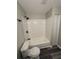 Tiled shower and tub combo with matte black showerhead and faucet fixtures at 3730 Clovis Nw Ct, Atlanta, GA 30331