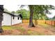 Large backyard featuring a wooden fence and mature trees, providing plenty of shade and privacy at 4296 Langdon Dr, Decatur, GA 30035