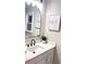 Modern bathroom with a sleek mirror, vanity, white marble countertop, and black faucet, giving a luxurious feel at 4296 Langdon Dr, Decatur, GA 30035
